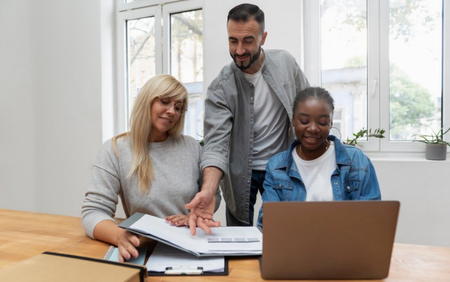 Student reviewing financial documents and taking notes at organized workspace